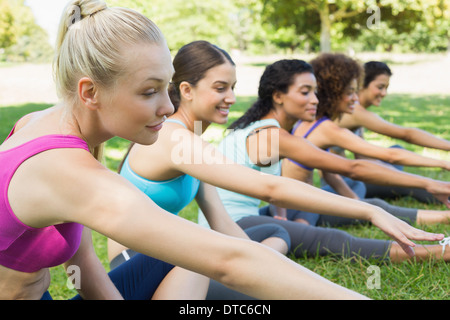 Determined friends stretching at park Stock Photo