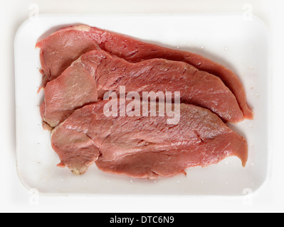 Three escalopes of veal on a polystyrene supermarket tray Stock Photo