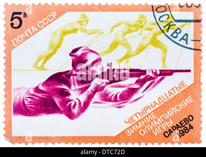 stamp printed in the USSR (Russia) shows Biathlon with inscription and name of series 'XIV Winter Olympic Games, Sarajevo, 1984 Stock Photo