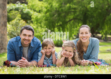 Portrait of parents and kids lying at park Stock Photo