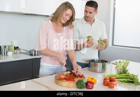 Couple preparing food in kitchen Stock Photo