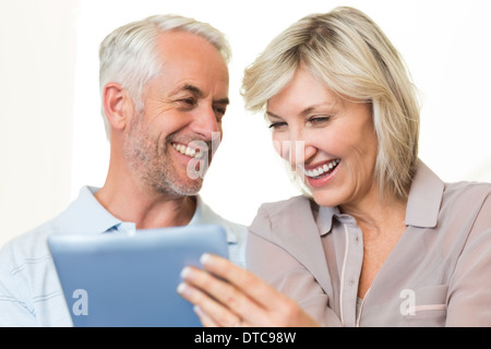 Closeup of cheerful mature couple using digital tablet Stock Photo
