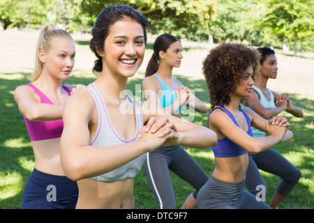 Beautiful woman exercising with friends Stock Photo