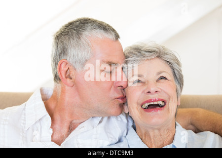 Senior man kissing happy wife Stock Photo