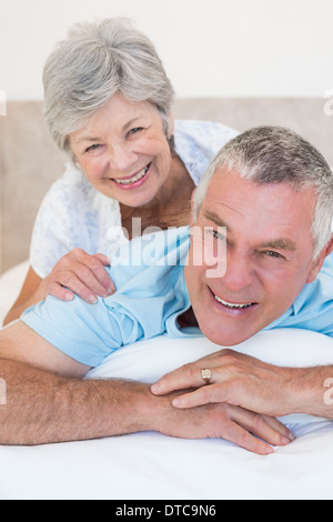 Loving senior couple relaxing in bed Stock Photo