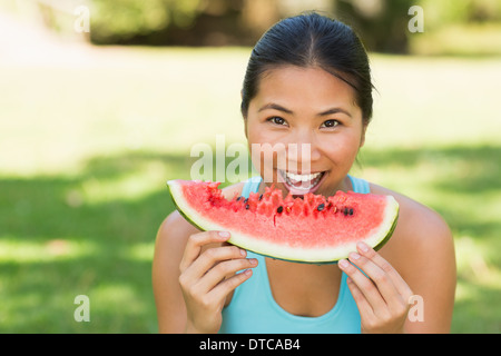 Portrait of a woman eating watermelon in park Stock Photo