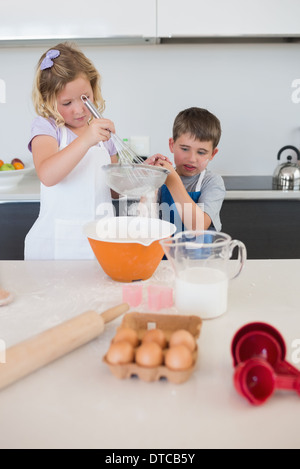 Children baking cookies in kitchen Stock Photo