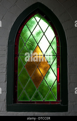 Stained glass window in a small church Stock Photo