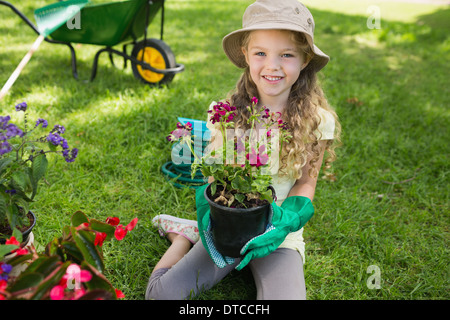 Smiling young girl engaged in gardening Stock Photo