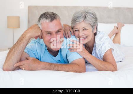 Loving senior couple lying in bed Stock Photo
