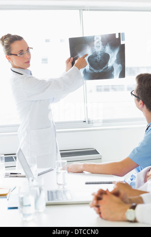 Professional doctor showing Xray to colleagues Stock Photo