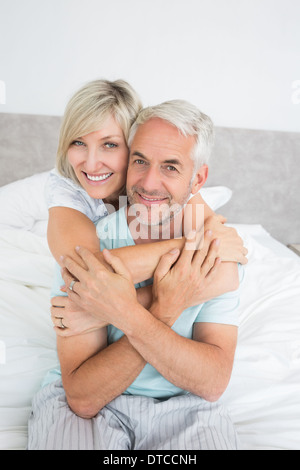 Portrait of a loving mature couple in bed Stock Photo