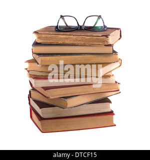 Stack of old books and spectacles in thick-rimmed, isolated on white background. Stock Photo