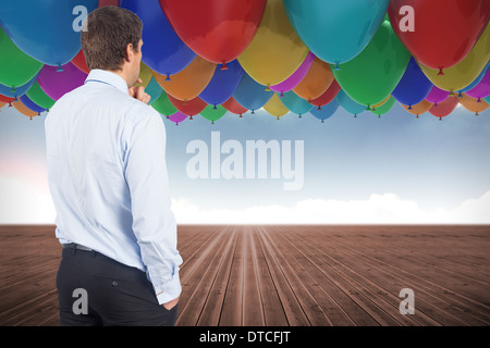 Composite image of thinking businessman touching his chin Stock Photo