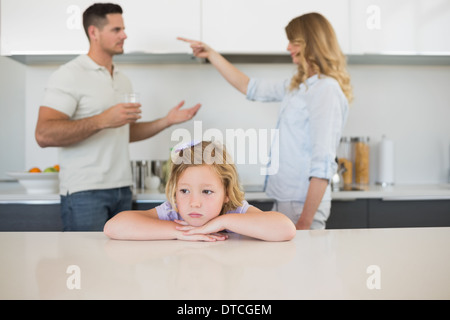 Sad girl against arguing parents Stock Photo