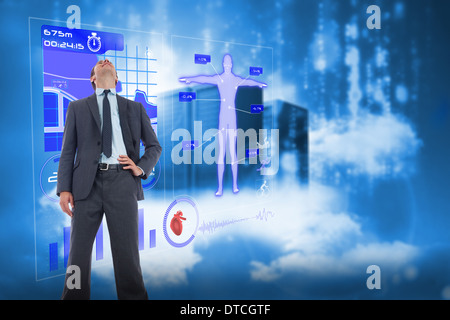 Composite image of happy businessman with hand on hip Stock Photo