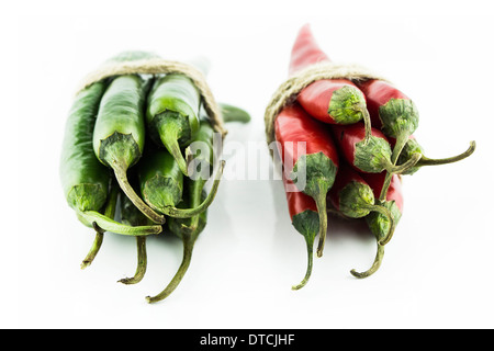 Two sets of red and green hot chili pepper on a white background Stock Photo