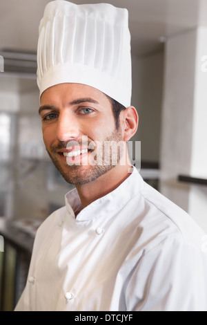 Happy young chef smiling at camera Stock Photo