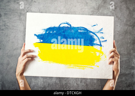 Ukraine flag. Man holding banner with Ukrainian Flag. Supporting national team, patriotism concept. Stock Photo