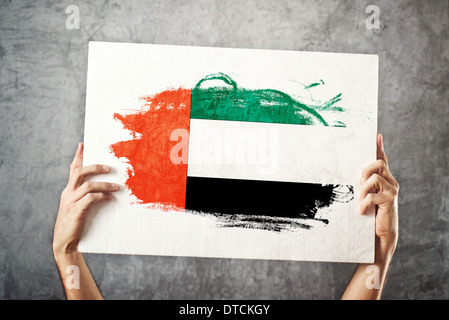 United Arab Emirates flag. Man holding banner with UAE Flag. Supporting national team, patriotism concept. Stock Photo