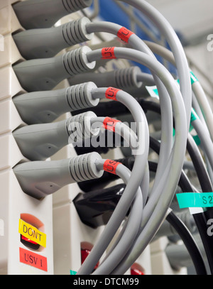 Chaotic arrangement of power cables coming out of a multiple switched socket-outlet. Stock Photo