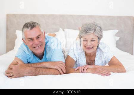 Senior couple lying in bed at home Stock Photo