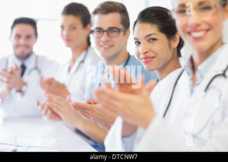 Confident nurse and doctors applauding Stock Photo