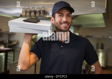 Smiling pizza delivery man holding two pizza boxes Stock Photo