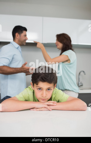 Closeup portrait of sad son while parents quarreling Stock Photo
