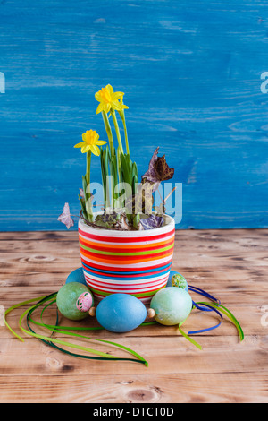 Daffodils in pot with wreath from Easter eggs, Easter decorations Stock Photo