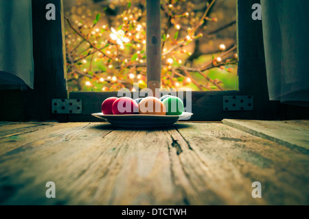 Colored eggs on a wooden table in a rural hut Stock Photo