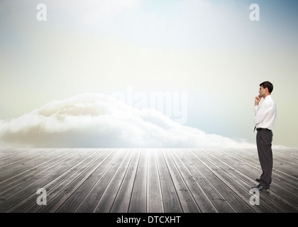 Composite image of thoughtful young businessman looking away Stock Photo