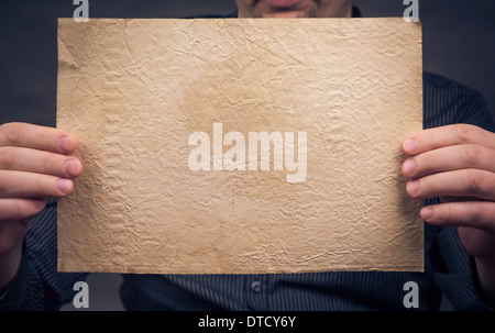 Old sheet of paper in his hands horizontally Stock Photo
