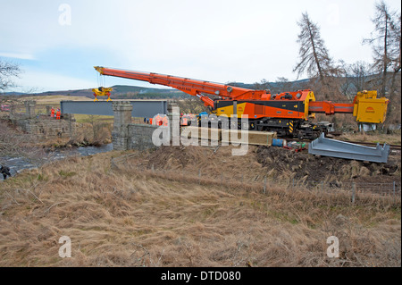 Steel supports from a dismantled bridge at Ravenscraig ready to cross the gap over the River Dulnain Strathspey. SCO 9038. Stock Photo