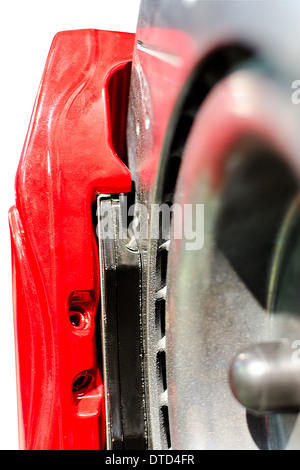 Closeup pads on disc car brake in red caliper isolated Stock Photo