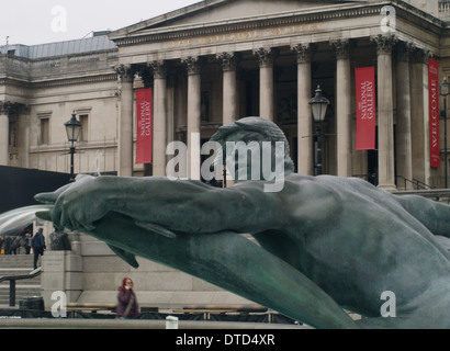 One of the fountain sculptures in Trafalgar Square, London with the National Gallery in the background Stock Photo