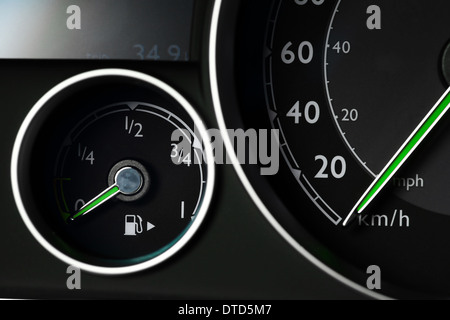 Close-up shot of a fuel gauge and a speedometer in a car Stock Photo