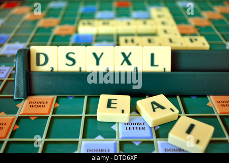 Scrabble board and tiles, mis-spelling the word dyslexia Stock Photo