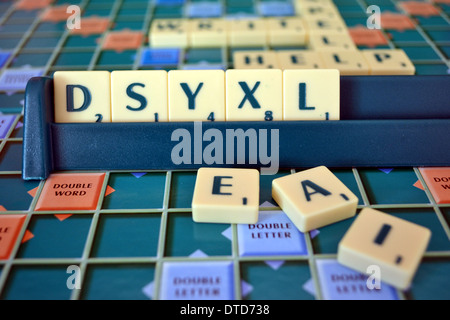 Scrabble board and tiles, mis-spelling the word dyslexia Stock Photo