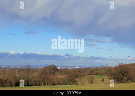 Epsom Downs, Surrey, England, UK. 15th February 2014. As more storms rage across the UK, a break in the clouds allows the sun to come out over Epsom Downs Golf course. The skyline of London is just visible in the distance. Credit:  Julia Gavin/Alamy Live News Stock Photo