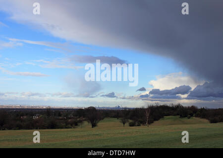 Epsom Downs, Surrey, England, UK. 15th February 2014. More storms rage across the UK. The London skyline is visible in the distance as dramatic rain filled clouds pass overhead at Epsom Downs Golf Course. Credit:  Julia Gavin/Alamy Live News Stock Photo