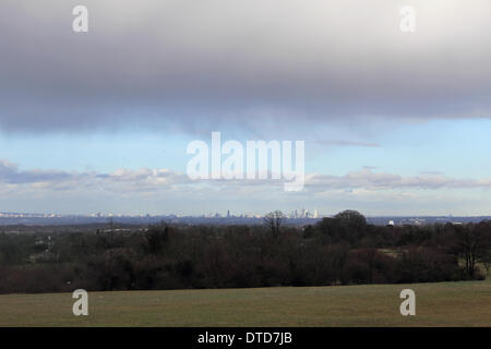Epsom Downs, Surrey, England, UK. 15th February 2014. As more storms rage across the UK, dramatic clouds pass overhead at Epsom Downs, the city skyline of London is visible in the distance. Credit:  Julia Gavin/Alamy Live News Stock Photo