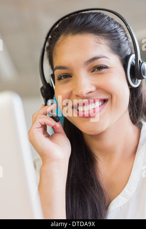 Smiling customer service representative wearing headset Stock Photo