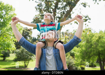 Father carrying a boy on his shoulders, Sweden Stock Photo - Alamy