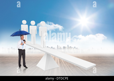 Composite image of happy businessman holding umbrella Stock Photo