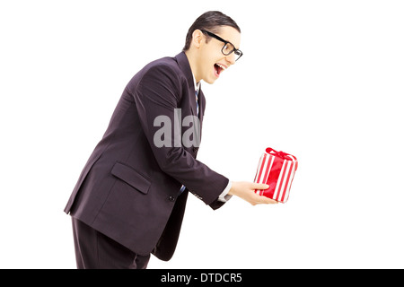 https://l450v.alamy.com/450v/dtdcr5/excited-young-man-in-black-suit-giving-a-present-dtdcr5.jpg