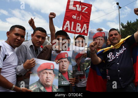 Caracas, Venezuela. 15th Feb, 2014. Demonstrators hold banners with the image of late President Hugo Chavez, during the 'March for Peace', called on Friday by Venezuelan President Nicolas Maduro, in the city of Caracas, capital of Venezuela, on Feb. 15, 2014. Credit:  AVN/Xinhua/Alamy Live News Stock Photo
