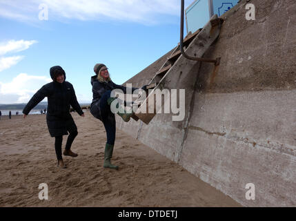 Exmouth beach, post storm damage, trying to use the now higher beach steps, Devon, Britain, UK Stock Photo