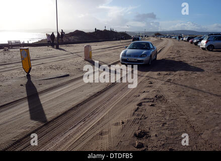 Exmouth beach, post storm damage, cars drive on the sand covered road, Devon, Britain, UK Stock Photo