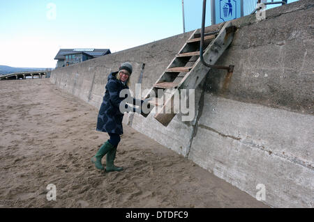 Exmouth beach, post storm damage, trying to use the now higher beach steps, Devon, Britain, UK Stock Photo